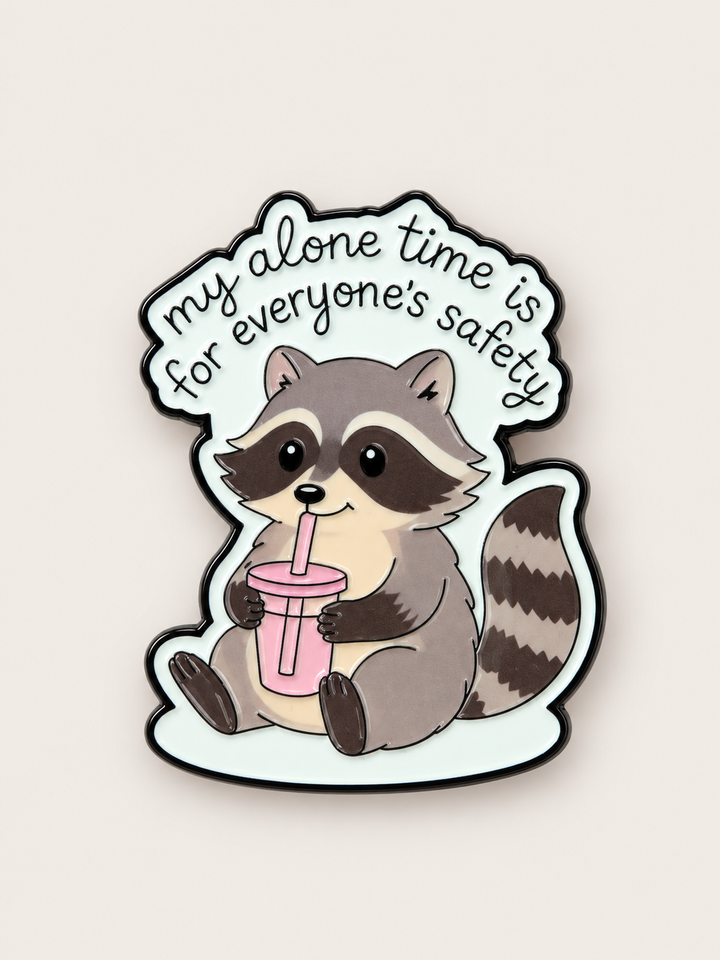Alone Time Raccoon Pin shown on a warm neutral background