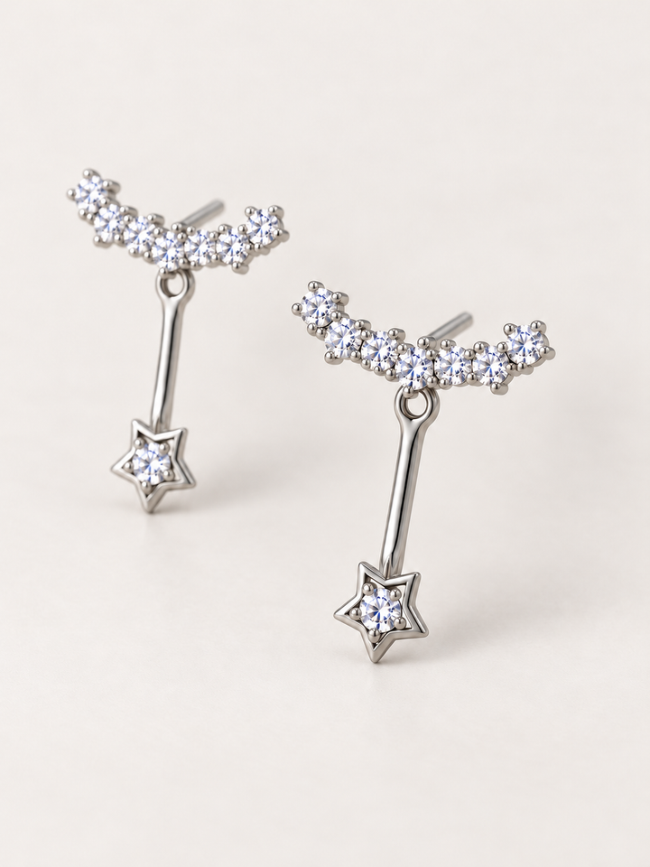 Crystal Star Ear Jacket Earrings shown angled on a warm neutral background