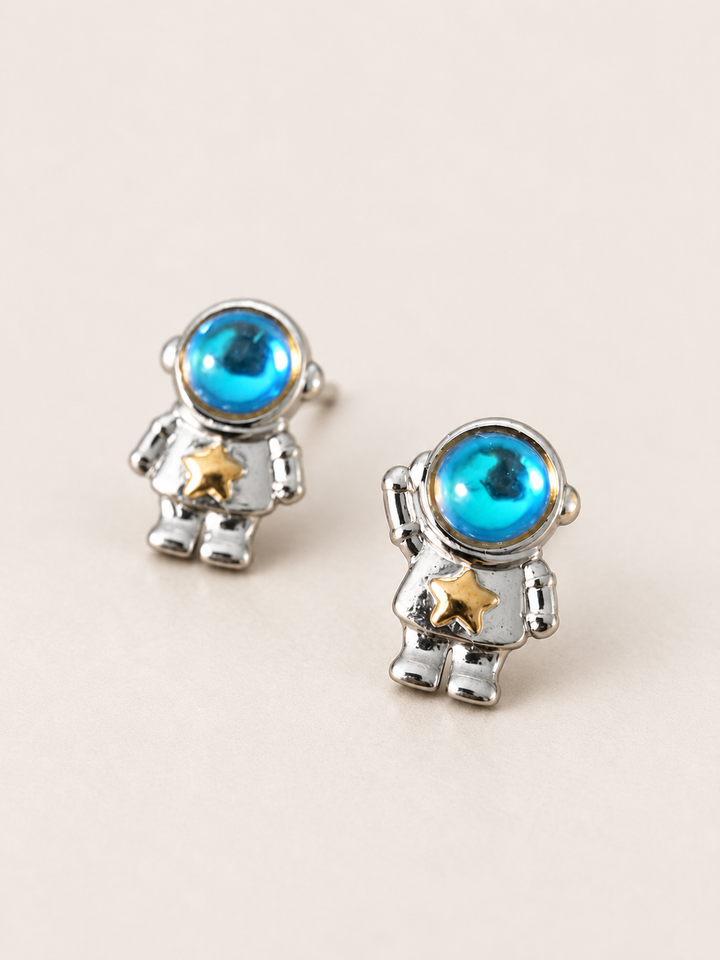 Astronaut Earrings shown angled on a warm neutral background