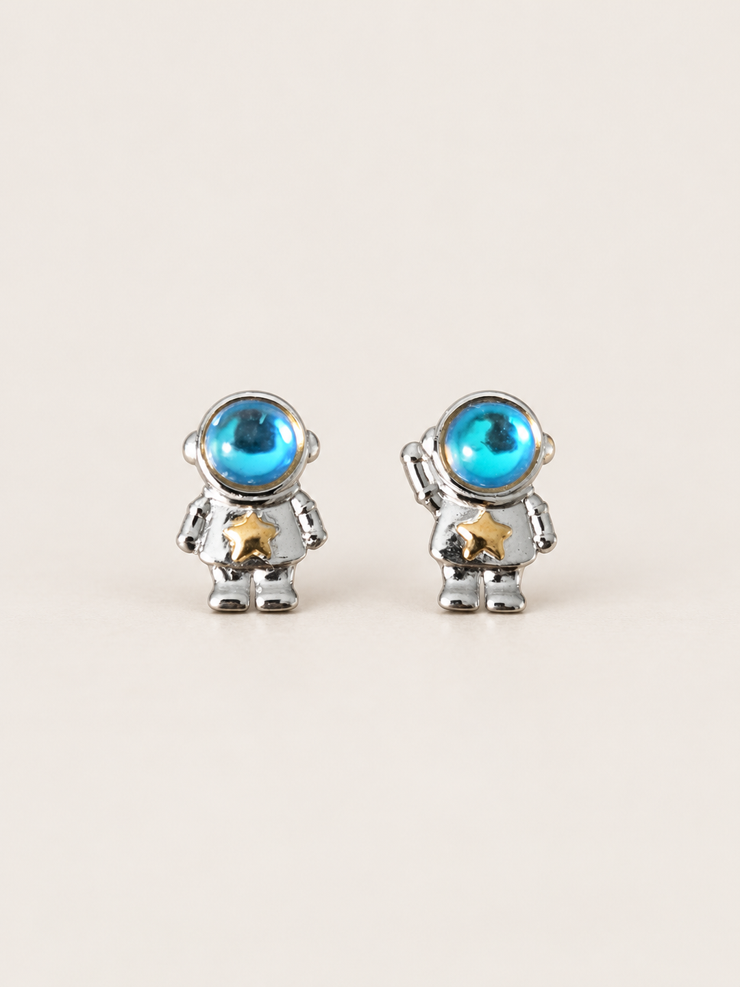 Astronaut Earrings shown on a warm neutral background