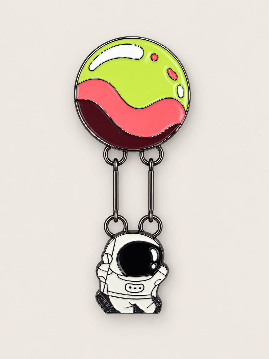Astronaut Hanging from Planet Pin shown on a warm neutral background