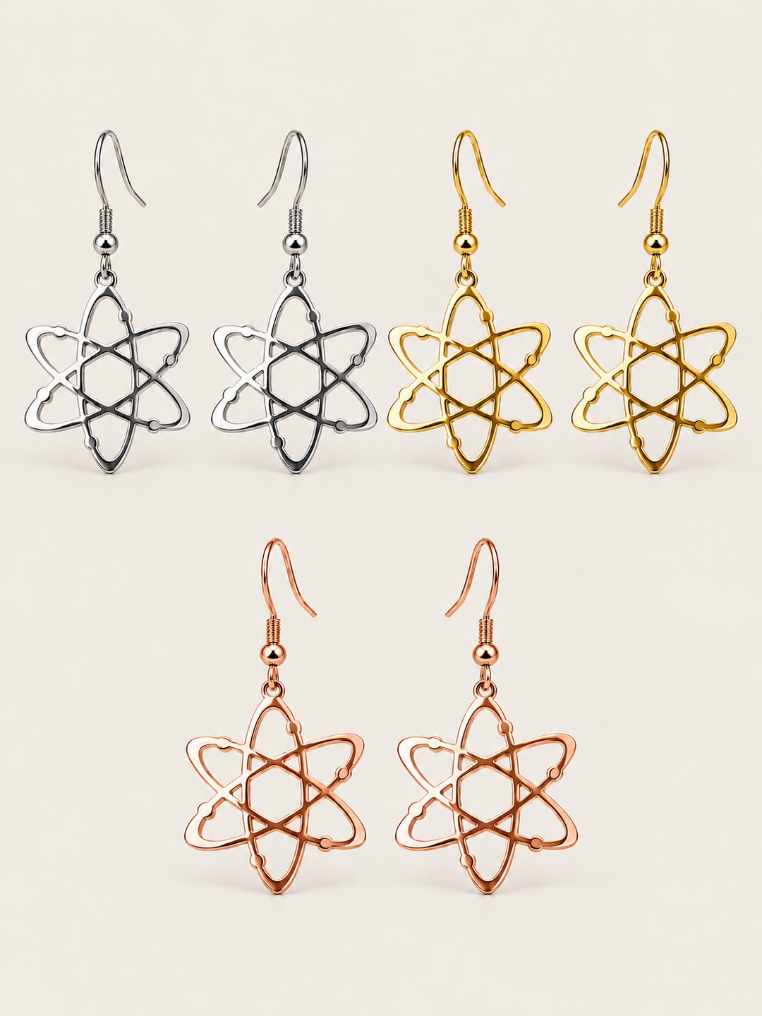 Atom Drop Earrings in silver, gold, and rose gold on a warm neutral background