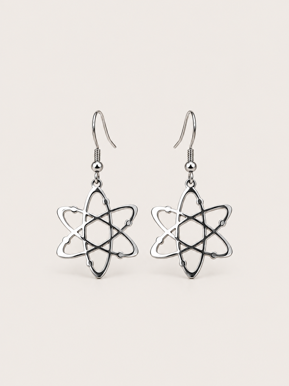Silver Atom Drop Earrings shown on a warm neutral background