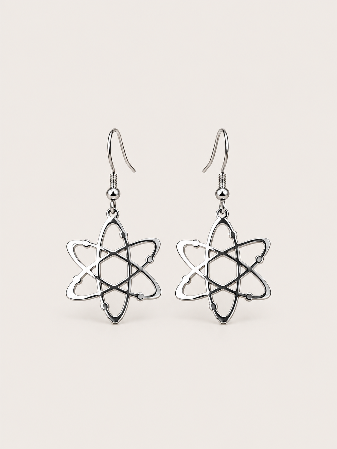 Silver Atom Drop Earrings shown on a warm neutral background