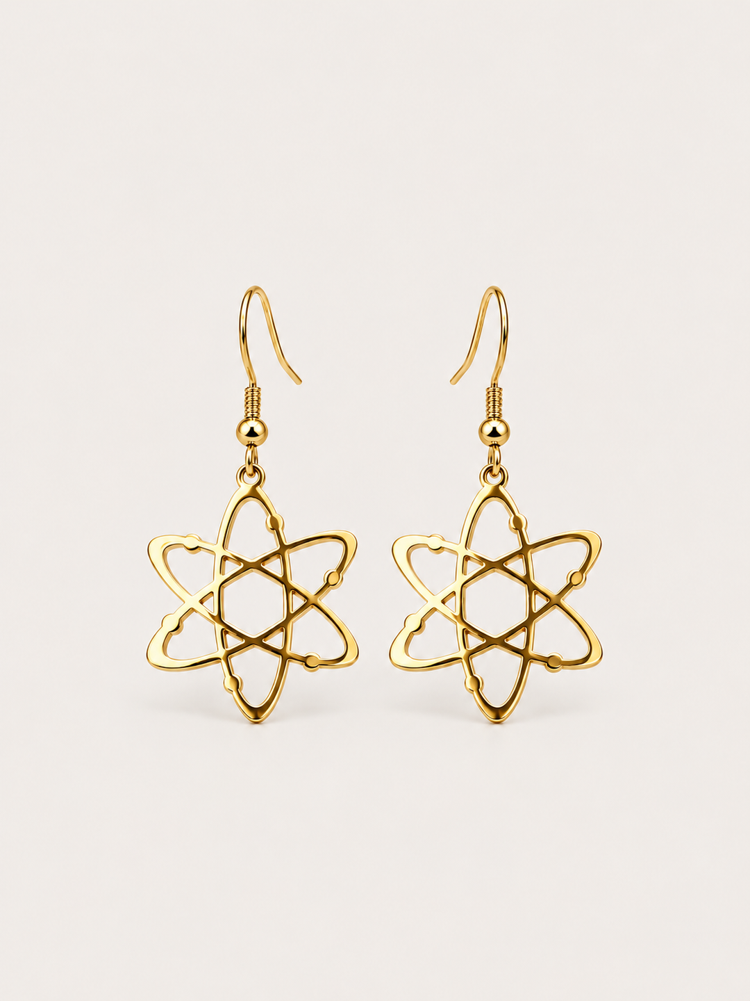 Gold Atom Drop Earrings shown on a warm neutral background
