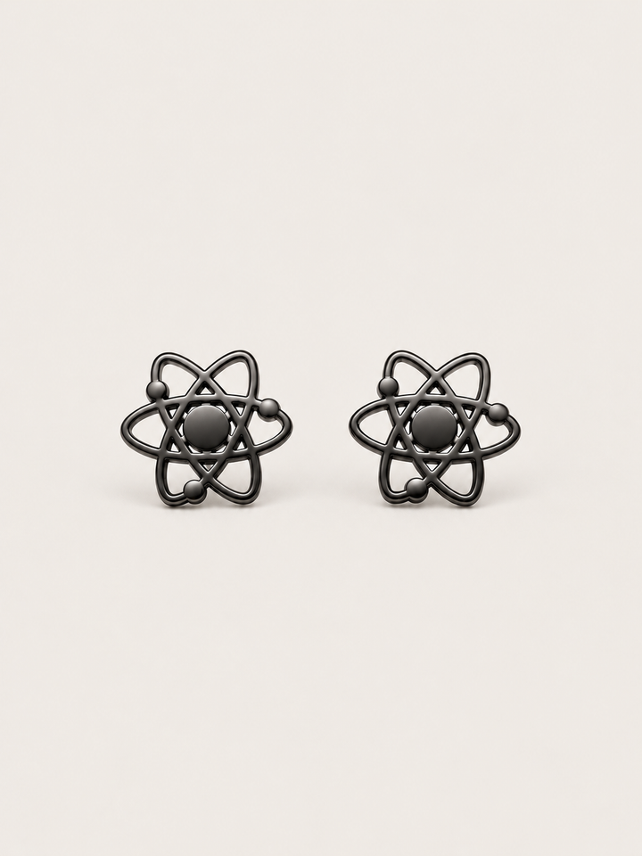 Atom Stud Earrings in black shown straight on on a warm neutral background