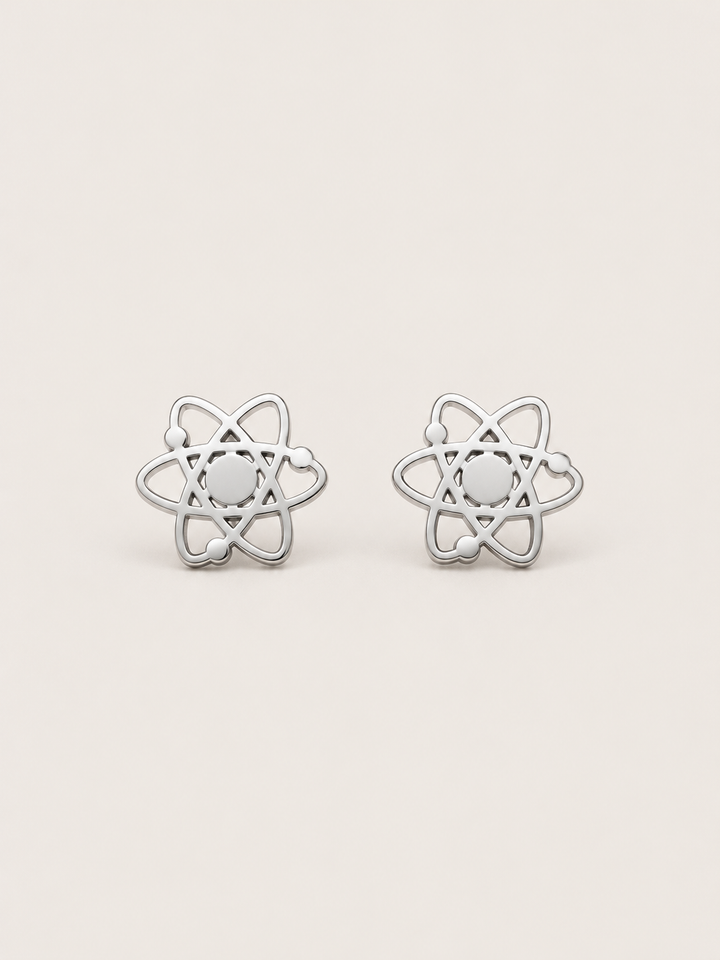 Atom Stud Earrings in silver shown straight on on a warm neutral background