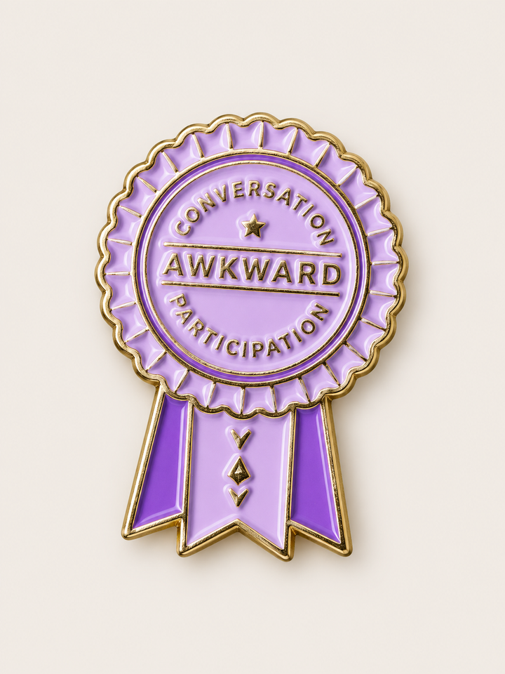Awkward Conversation Participation Ribbon Pin shown on a warm neutral background