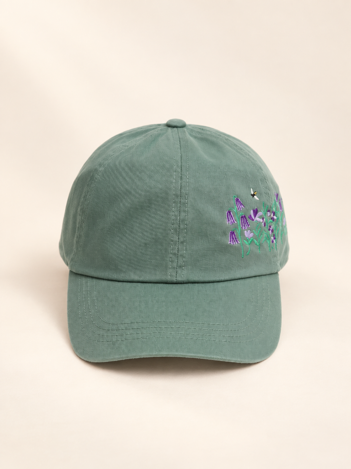 Front view of sage baseball cap with side flower and bee embroidery