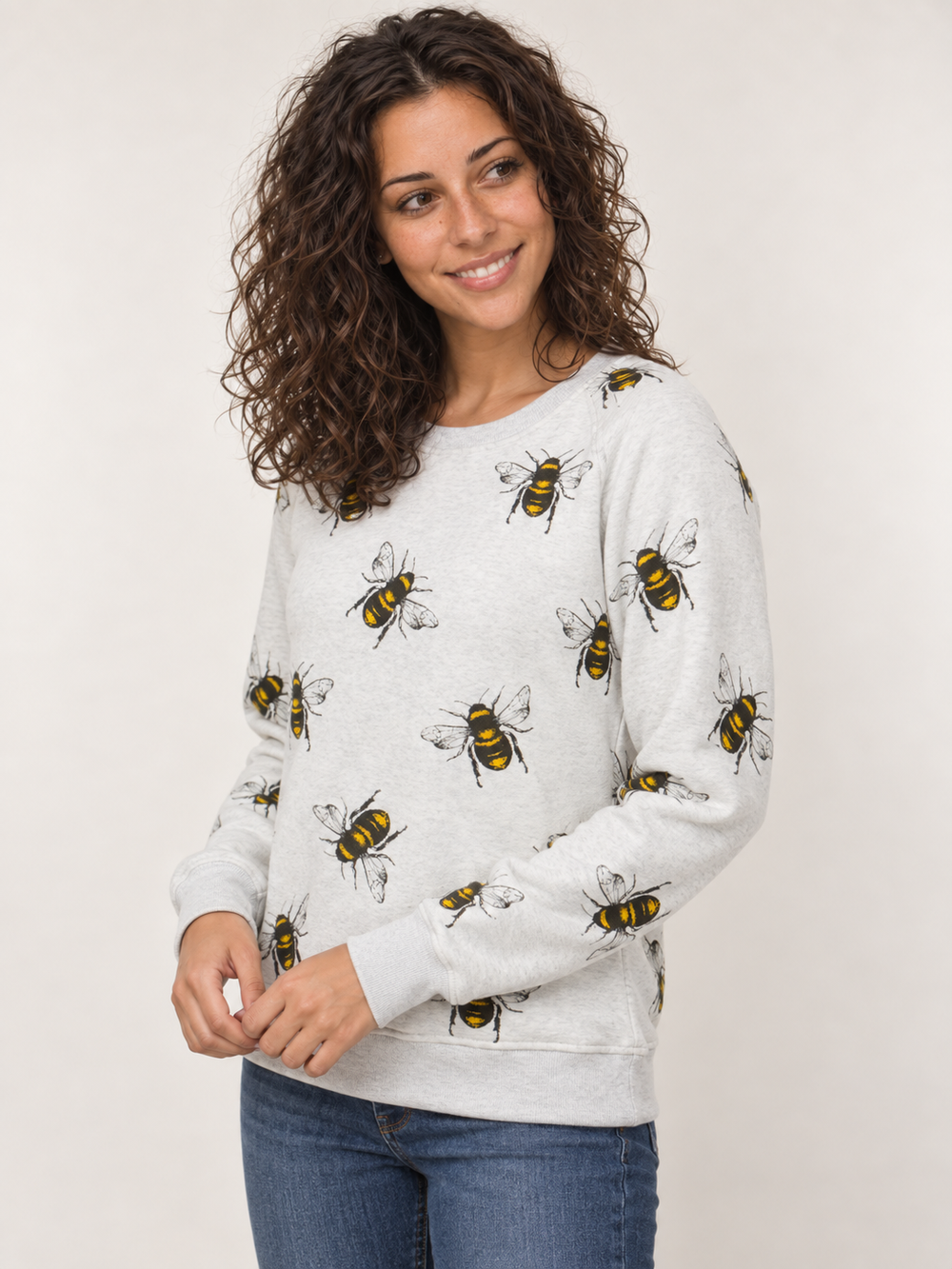 Model wearing bee sweatshirt, angled view