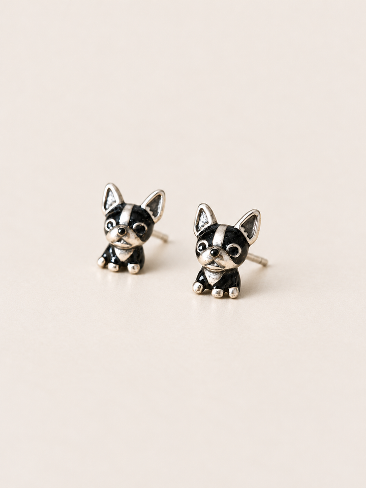 Black Dog Stud Earrings shown angled on a warm neutral background