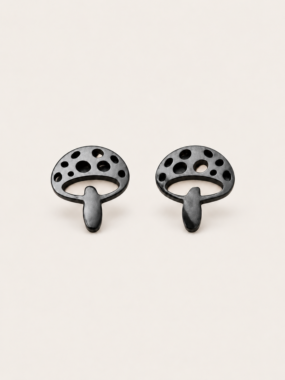 Black Mushroom Stud Earrings shown on a warm neutral background