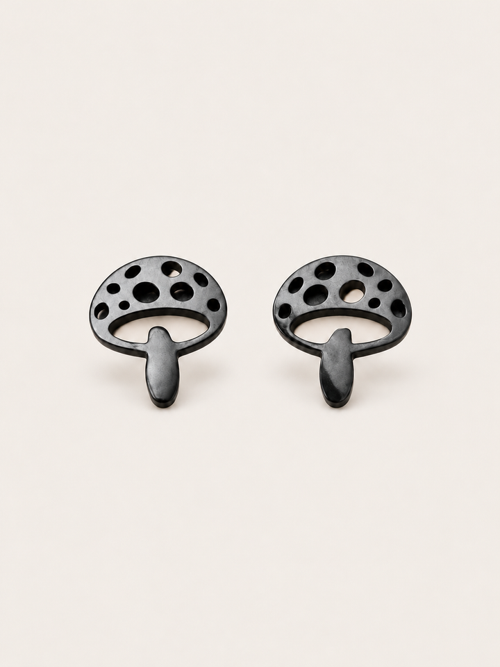 Black Mushroom Stud Earrings shown on a warm neutral background