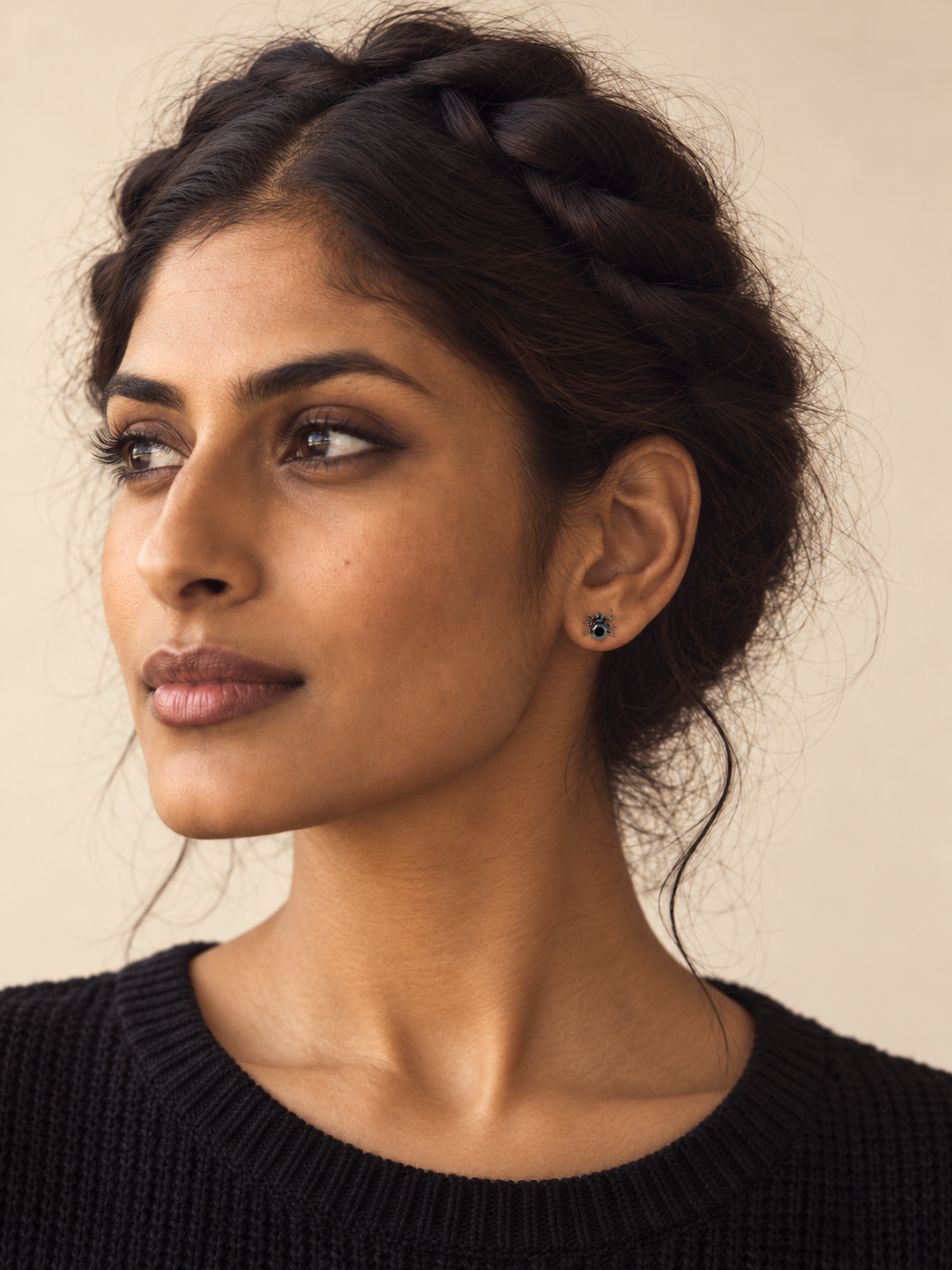 Black Spider Stud Earrings worn on a model's viewer-right ear