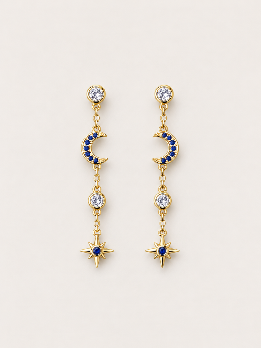 Blue Moon and Star Drop Earrings shown on a warm neutral background