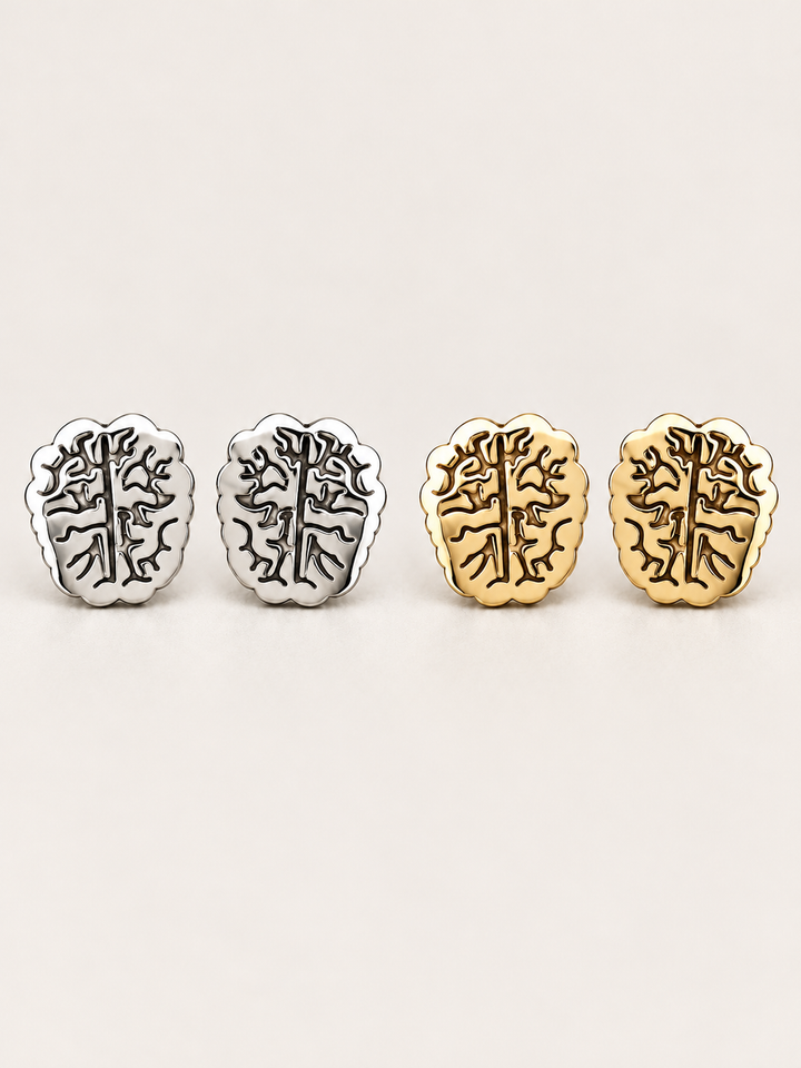 Brain Stud Earrings in silver and gold shown on a warm neutral background
