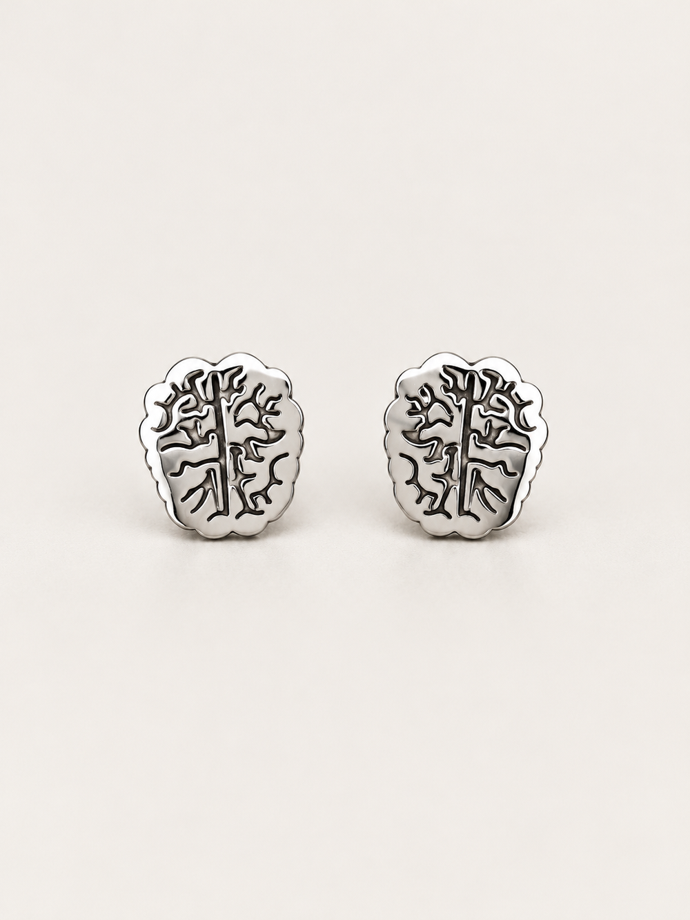 Silver Brain Stud Earrings shown on a warm neutral background