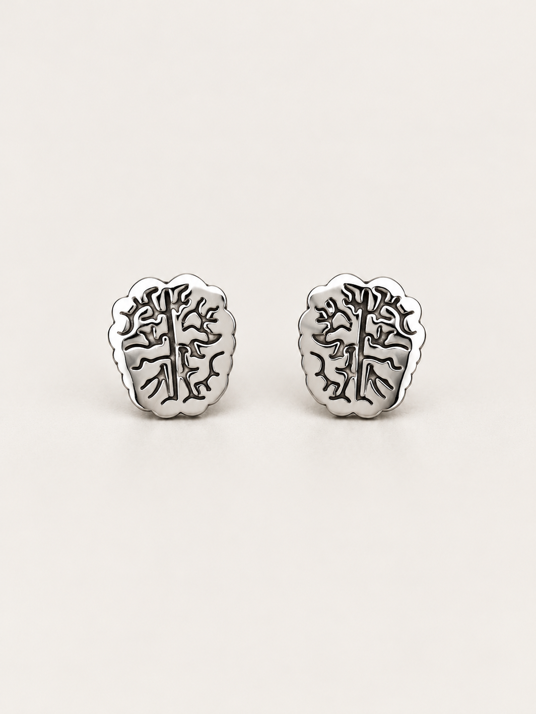Silver Brain Stud Earrings shown on a warm neutral background
