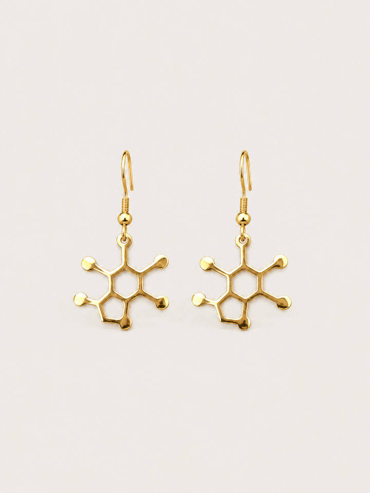 Gold Caffeine Molecule Earrings shown on a warm neutral background