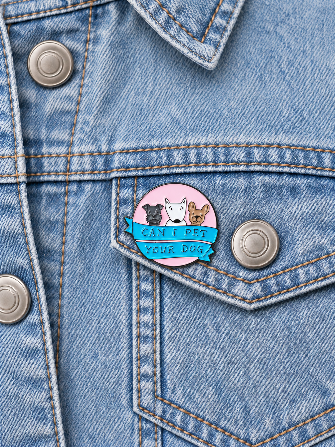 Can I Pet Your Dog Pin displayed on a light-wash denim jacket beside a metal button