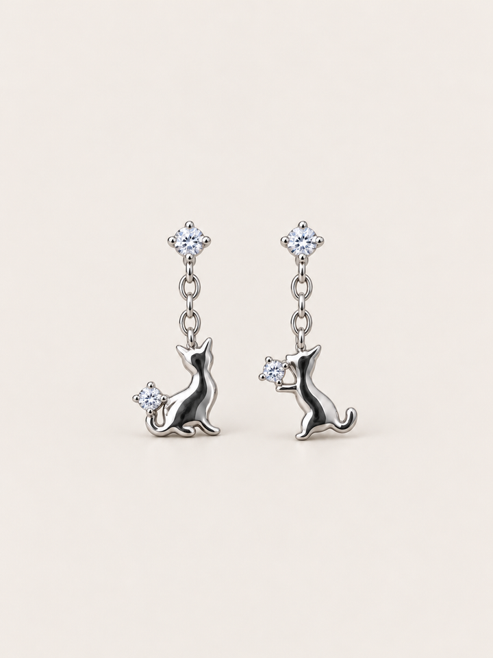 Silver Cat Crystal Drop Earrings shown on a warm neutral background
