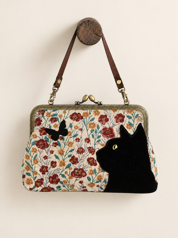 Cat Kisslock Bag hanging from short strap