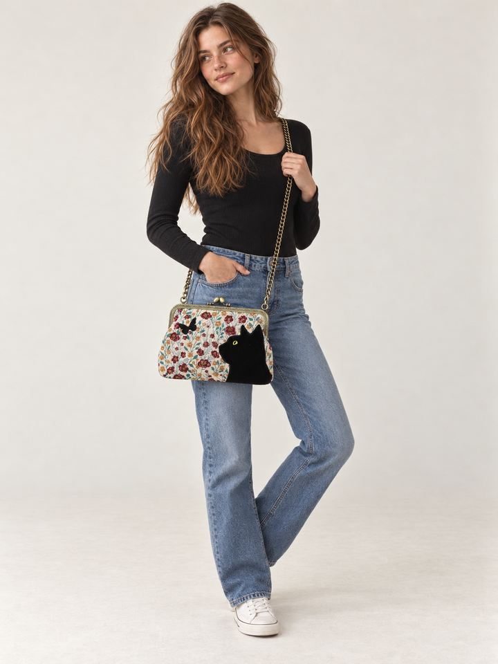Model wearing Cat Kisslock Bag with chain strap at the hip
