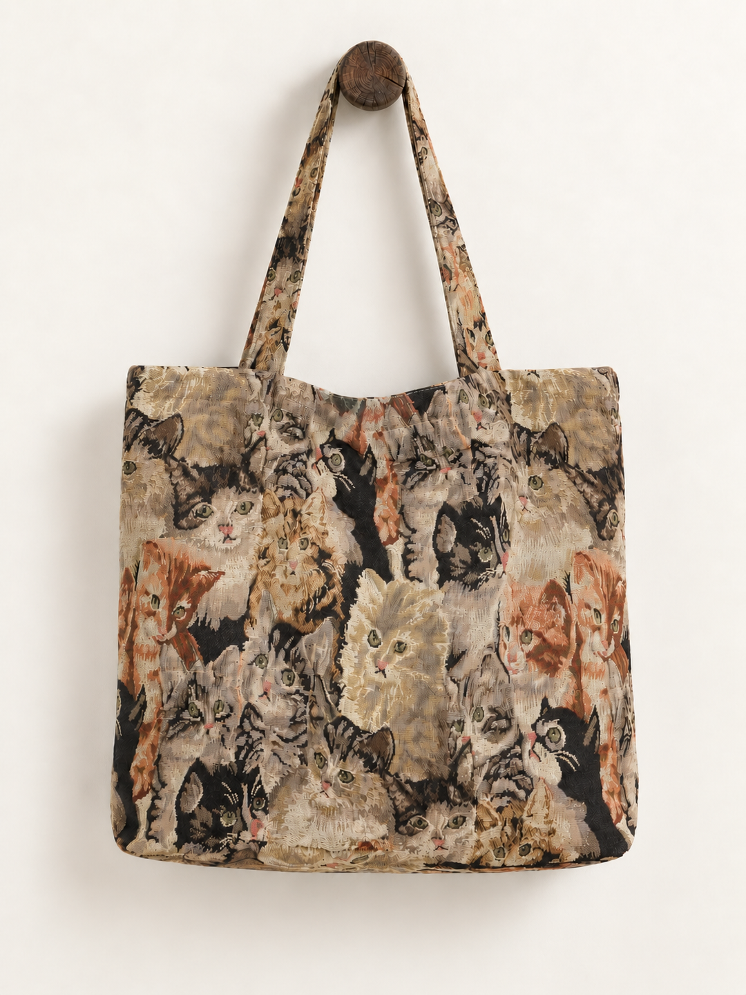 Cat tapestry tote bag hanging from wooden peg