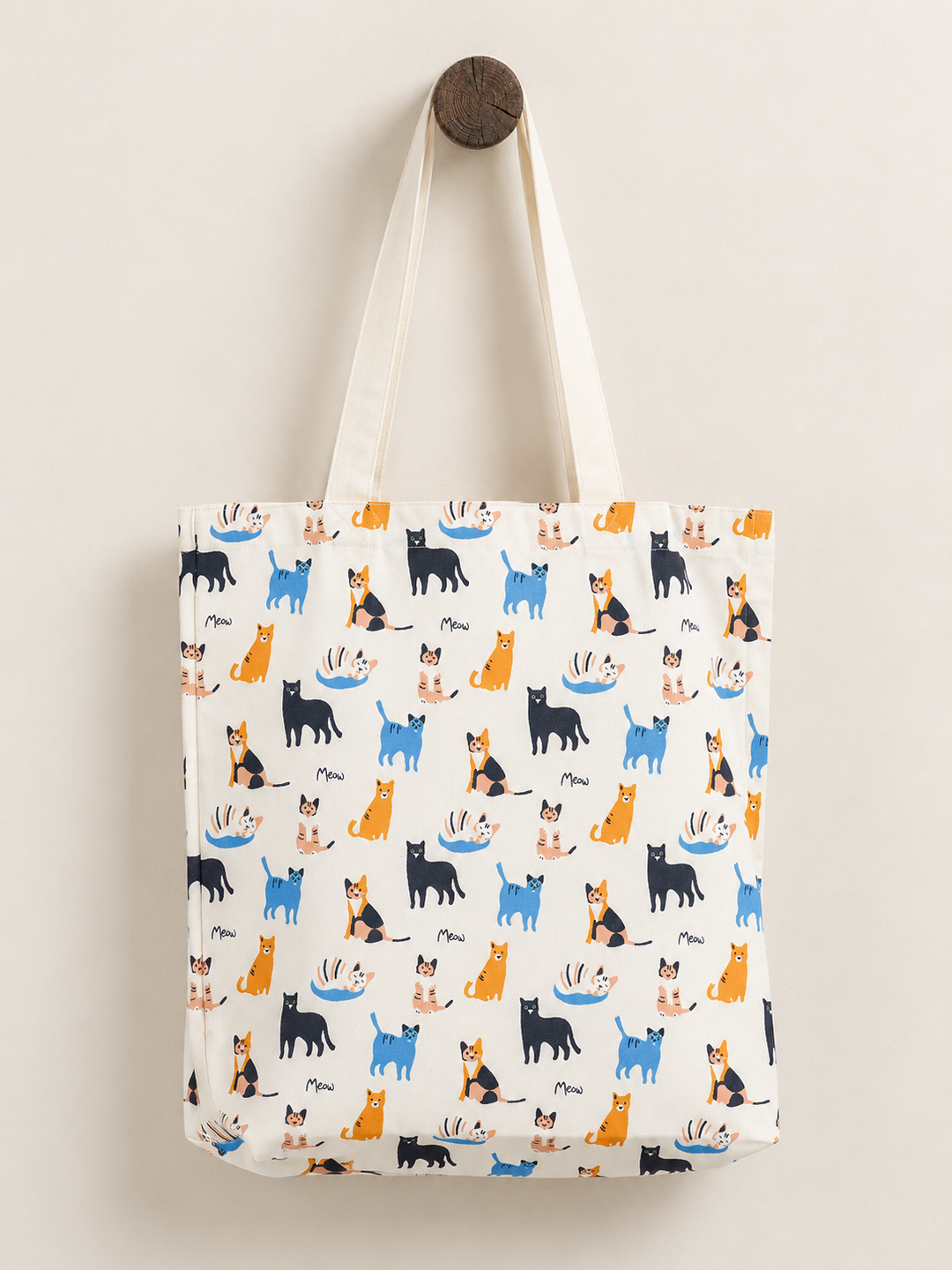 Cat tote bag hanging from a wooden post