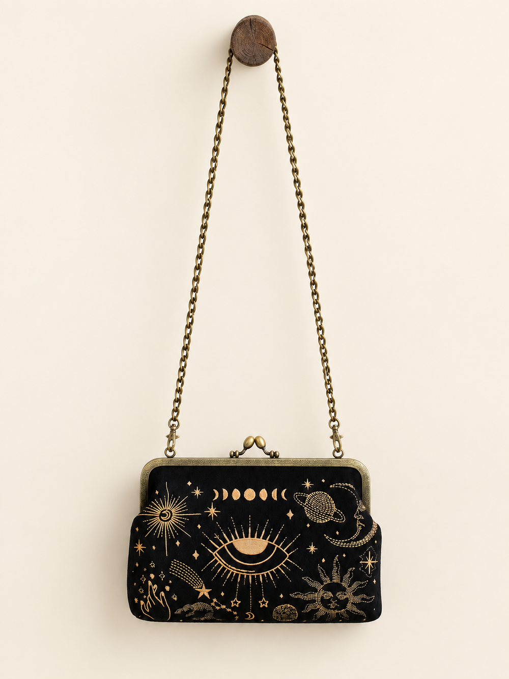 Celestial Kisslock Bag hanging from long chain strap