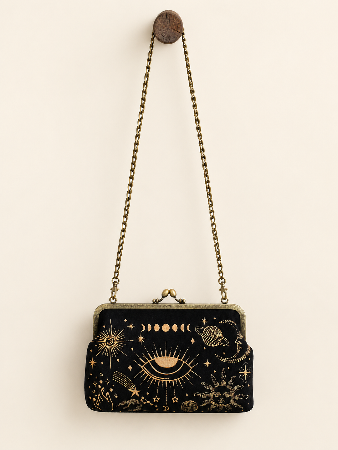 Celestial Kisslock Bag hanging from long chain strap