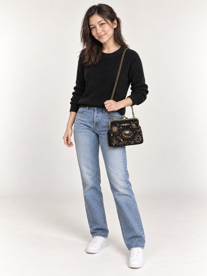 Model wearing Celestial Kisslock Bag with chain strap at hip