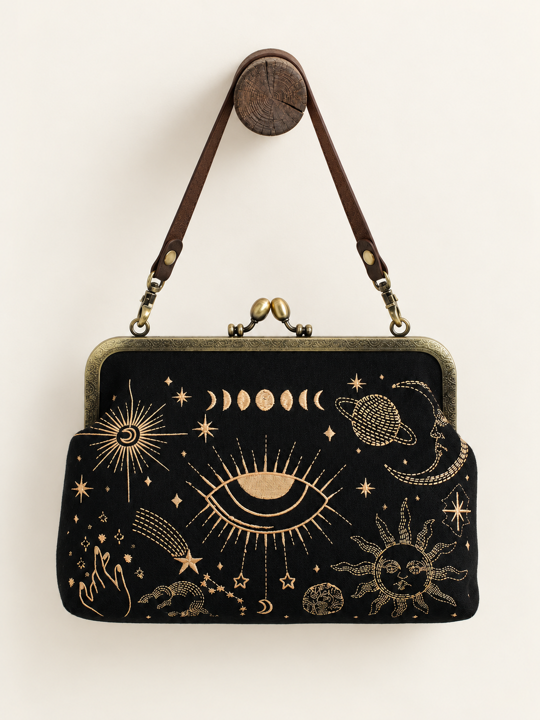Celestial Kisslock Bag hanging from short vinyl strap