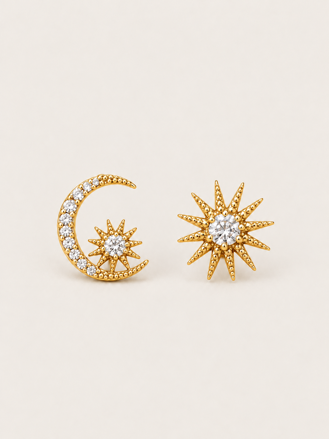 Gold Celestial Moon and Starburst Earrings shown on a warm neutral background