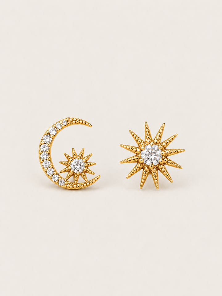 Gold Celestial Moon and Starburst Earrings shown on a warm neutral background