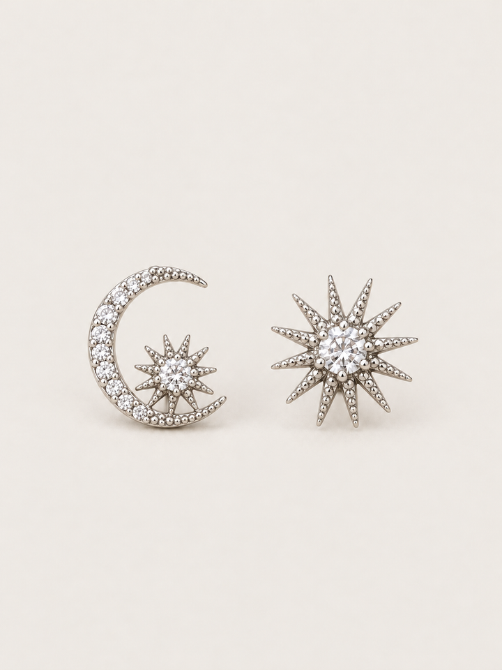 Silver Celestial Moon and Starburst Earrings shown on a warm neutral background