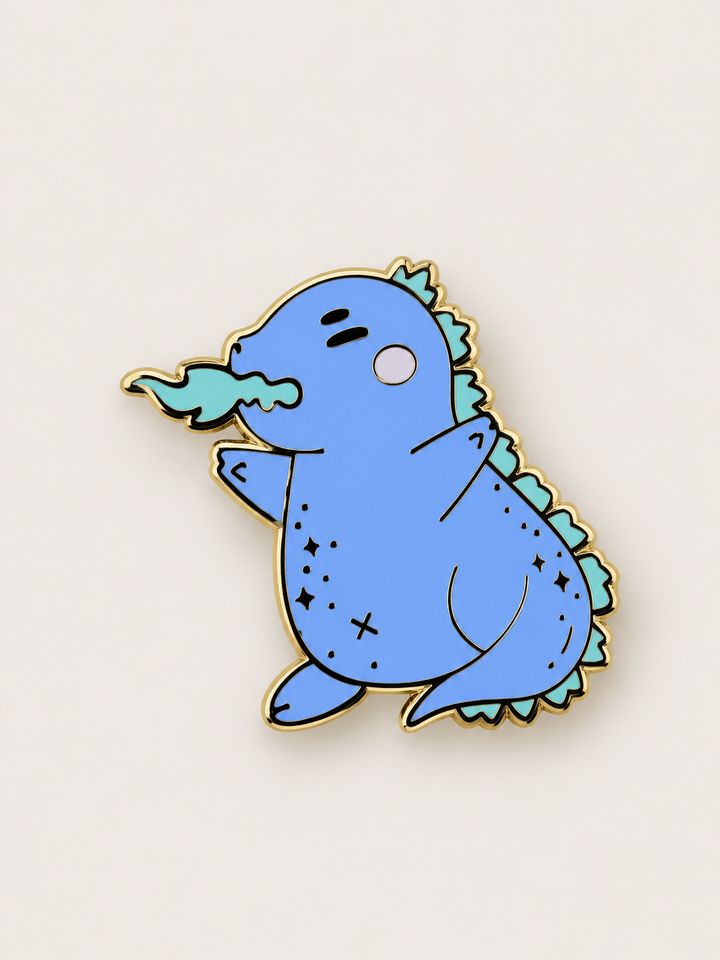 Chubby Blue Dragon Pin shown on a warm neutral background