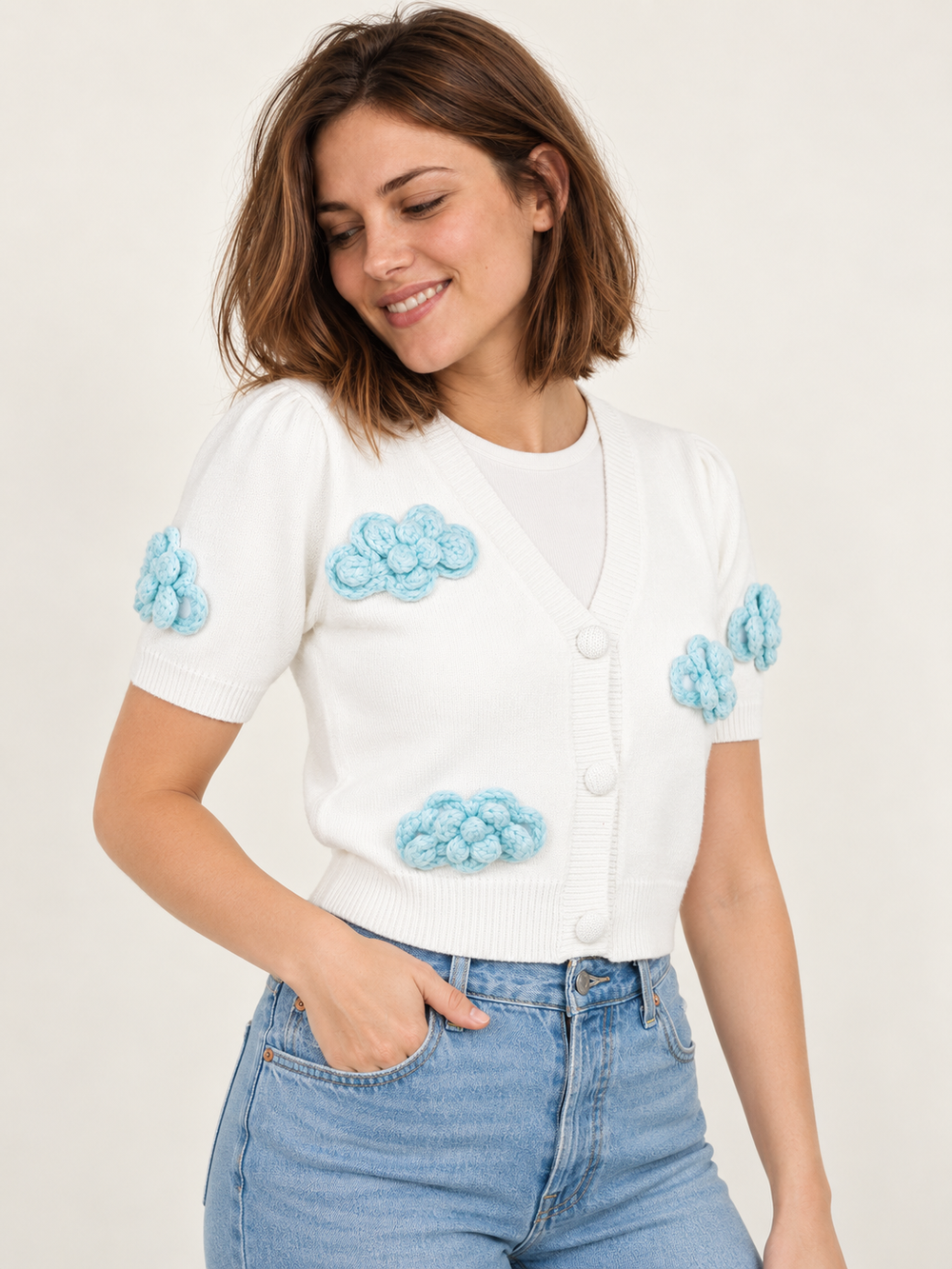 Model wearing Cloud Short Sleeve Cardigan Ivory — three-quarter view