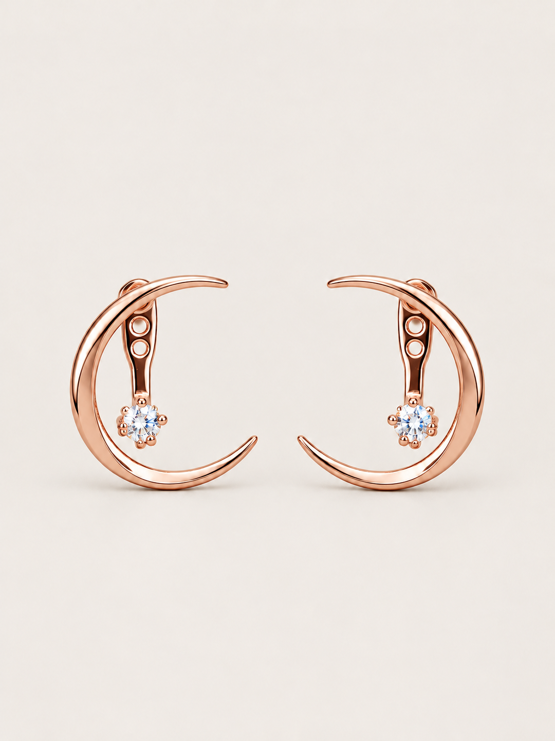 Crescent Moon Ear Jacket Earrings in Rose Gold shown on a warm neutral background