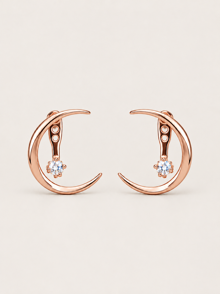 Crescent Moon Ear Jacket Earrings in Rose Gold shown on a warm neutral background
