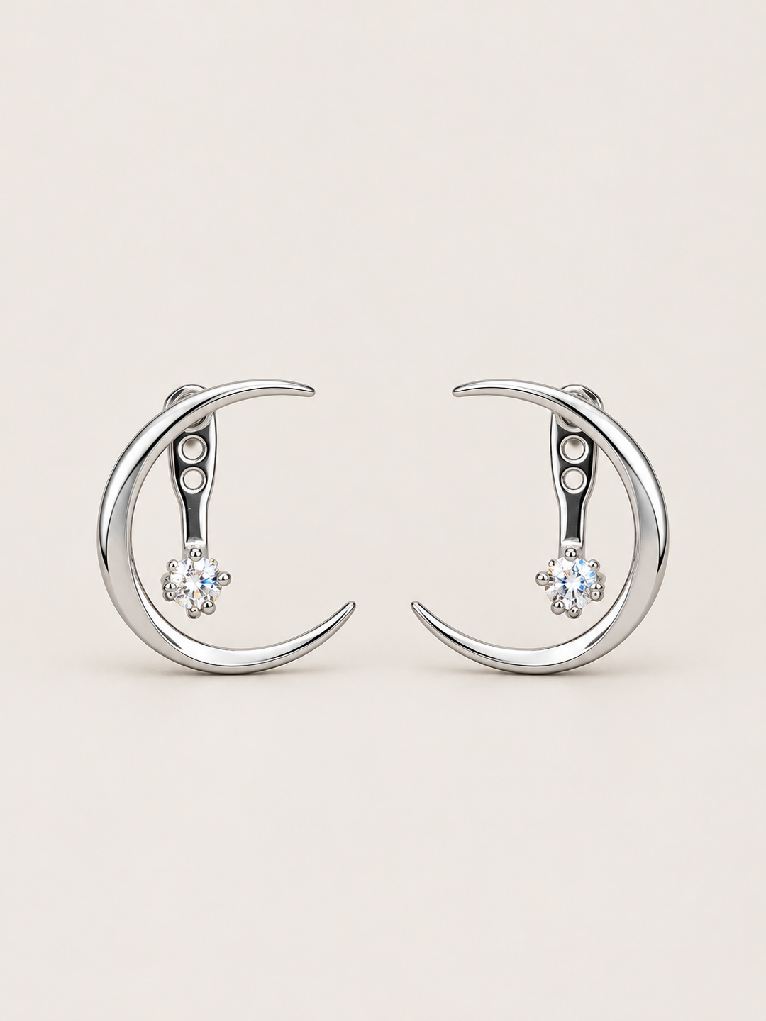 Crescent Moon Ear Jacket Earrings in Silver shown on a warm neutral background