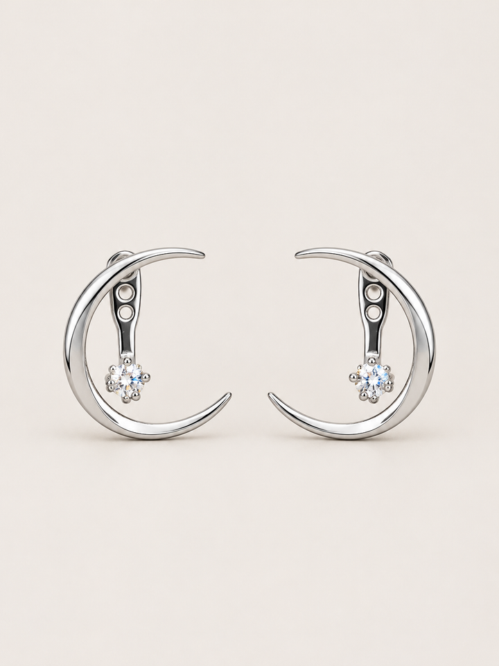 Crescent Moon Ear Jacket Earrings in Silver shown on a warm neutral background
