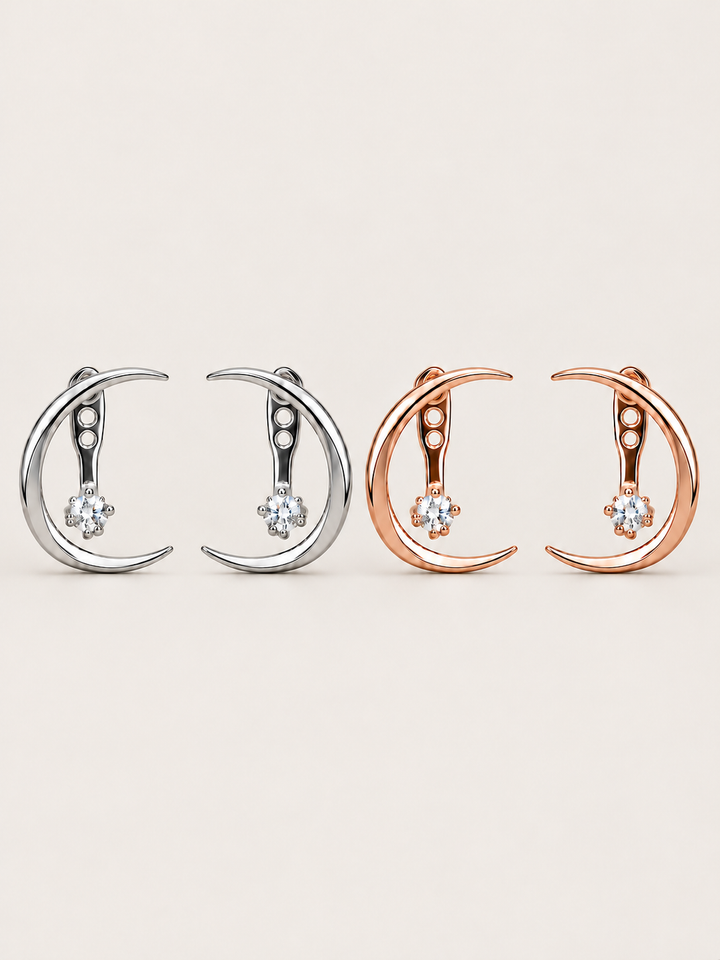 Crescent Moon Ear Jacket Earrings in Silver and Rose Gold shown on a warm neutral background