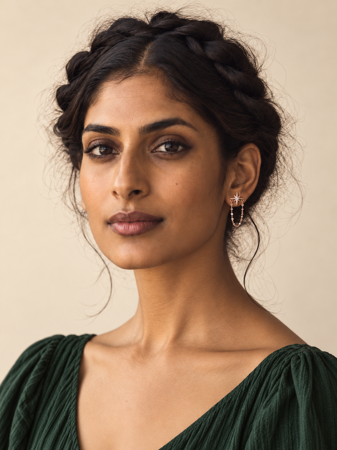 Rose gold star and chain earring worn naturally on a model's anatomical right ear