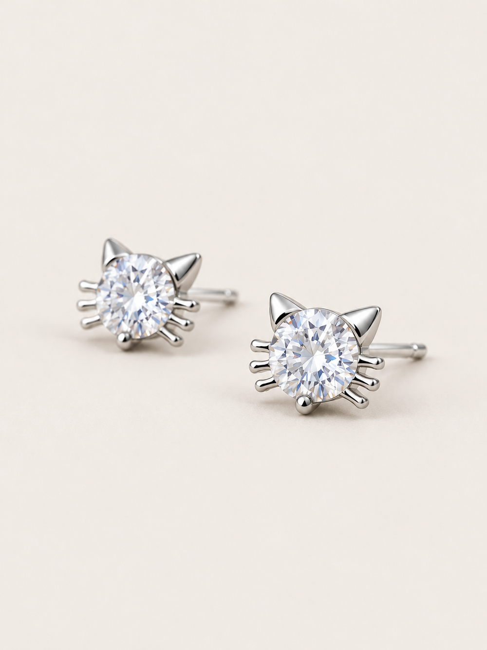 Crystal Cat Stud Earrings shown angled on a warm neutral background