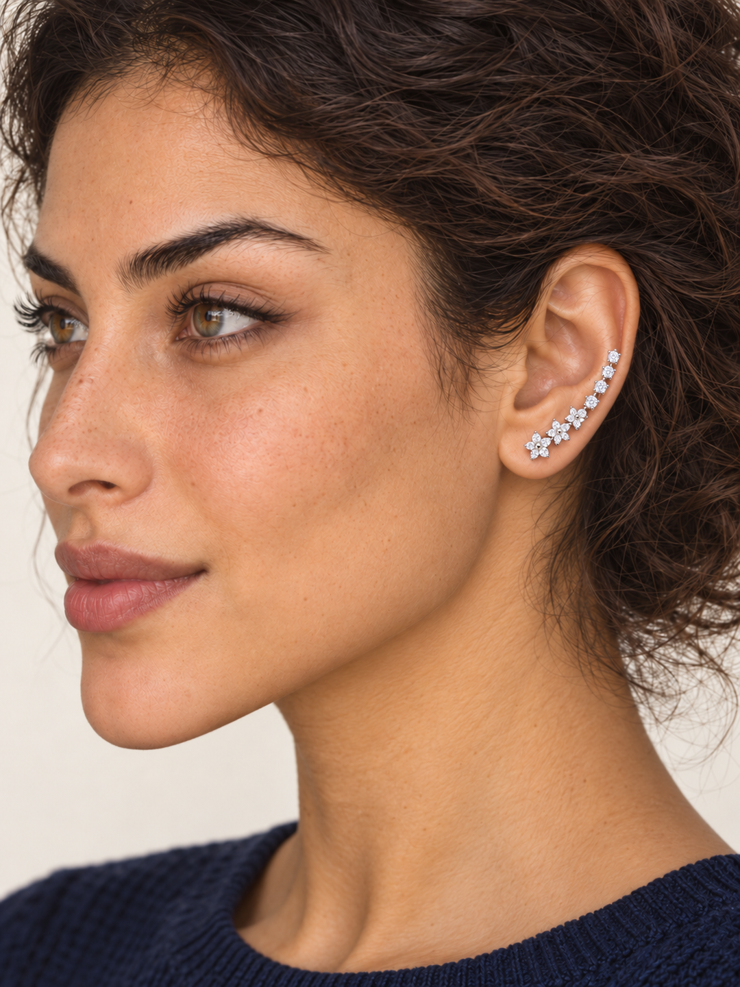 Silver Crystal Flower Ear Crawler Earrings worn higher on the model's earlobe