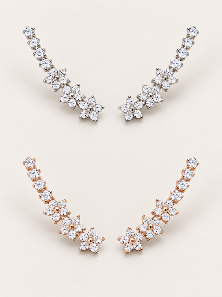 Crystal Flower Ear Crawler Earrings in silver above rose gold on a warm neutral background