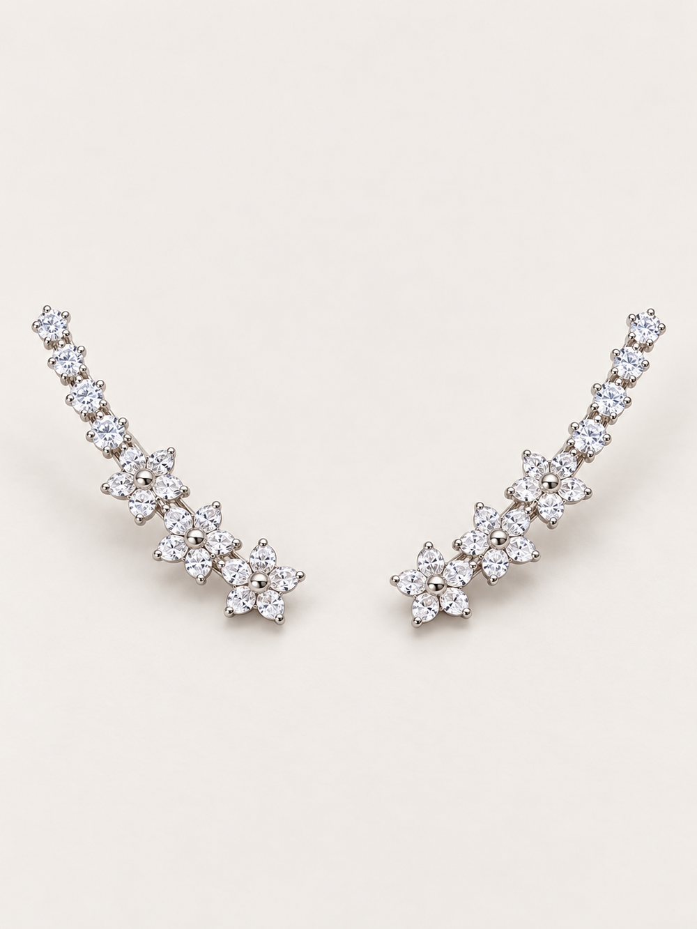 Silver Crystal Flower Ear Crawler Earrings on a warm neutral background