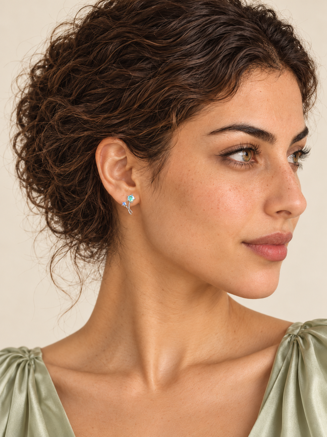 Crystal Flower Earrings with two stones and crossing stems on a model's viewer-left ear