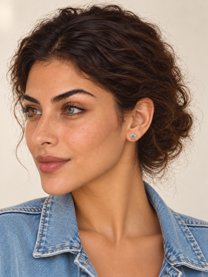 Crystal Paw Print Stud Earrings — Silver worn on a model